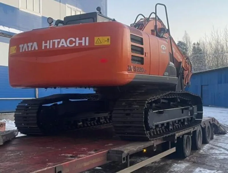 Экскаватор Tata Hitachi на низкорамном трале на площадке в Ленинградской области